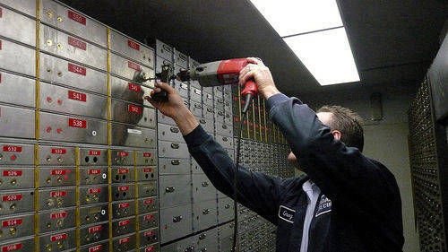 locksmith technician drilling bank deposit safes door